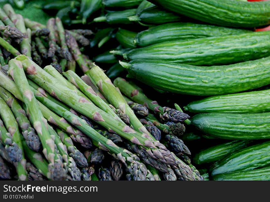 Pile of fresh asparagus and cucumbers. Pile of fresh asparagus and cucumbers.