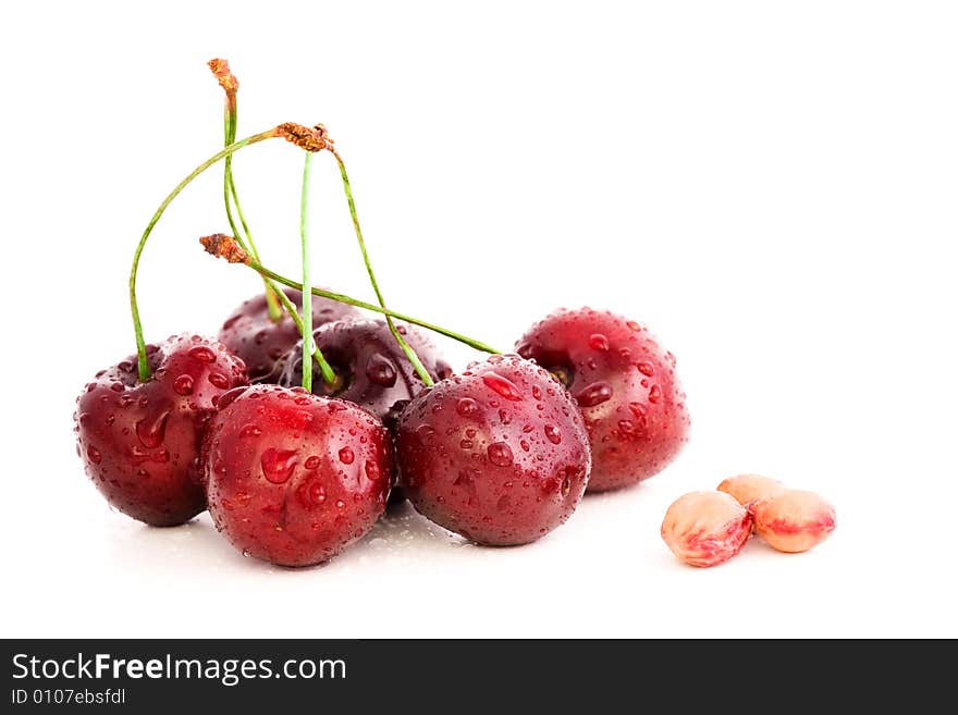 High resolution image of wet, fresh cherries and stones