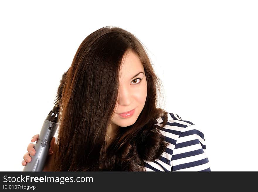 Beautiful brunette woman drying her hair with a dryer. Beautiful brunette woman drying her hair with a dryer