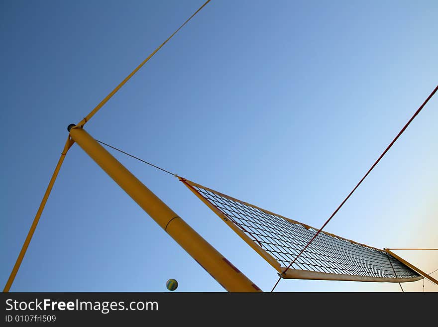 Yellow beach volley ball net with a blue sky background. Yellow beach volley ball net with a blue sky background