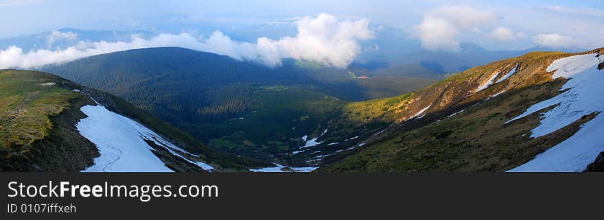 Panoramic photo slightly snowcapped ridge of Carpathian Mountains