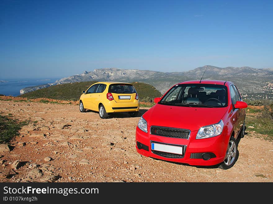 Two small family cars in mountains