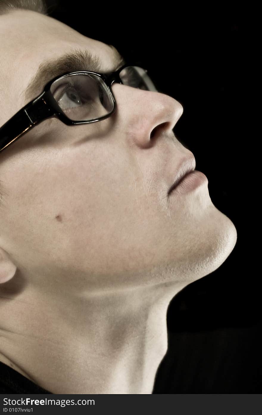 stylish young man with glasses looking up. stylish young man with glasses looking up.