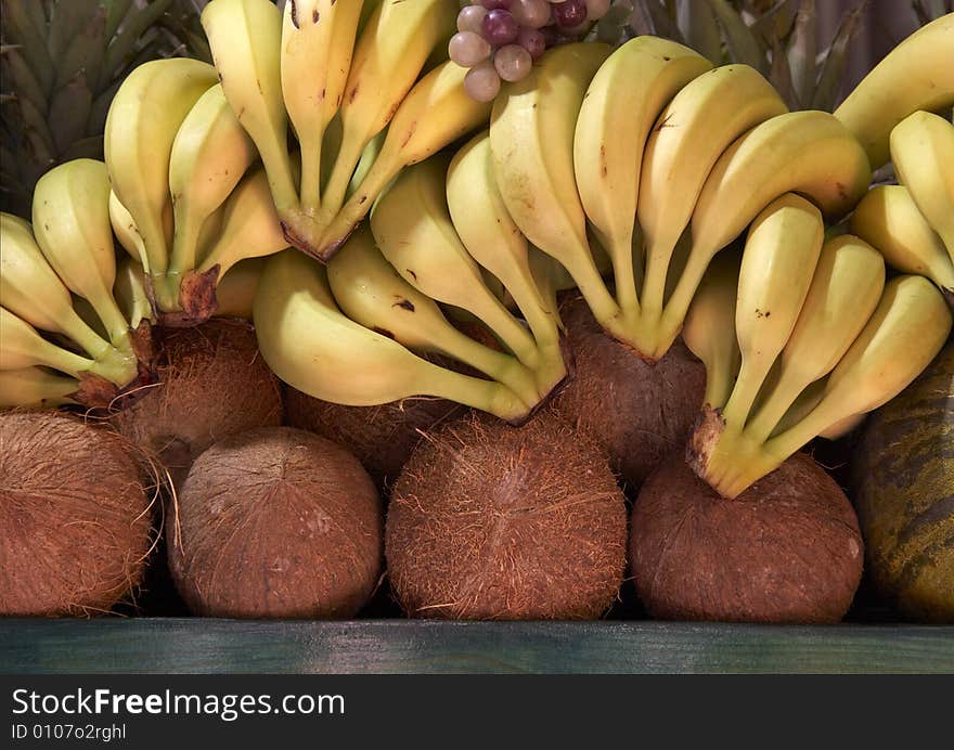 Bananas and coconuts on display in a city centre shop. Bananas and coconuts on display in a city centre shop.