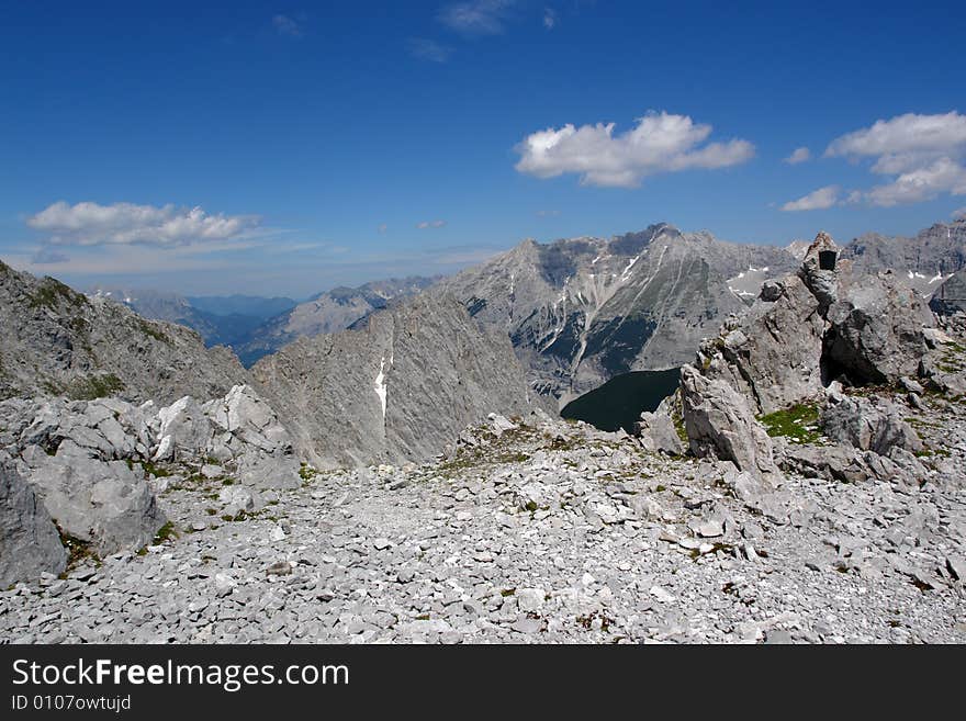 Clouds above the mountains Austrian  Alpes . The snow on the rocks. Sight from the peak of Hafelkarspitze mountain .Not so far from Innsbruck  . Clouds above the mountains Austrian  Alpes . The snow on the rocks. Sight from the peak of Hafelkarspitze mountain .Not so far from Innsbruck  .