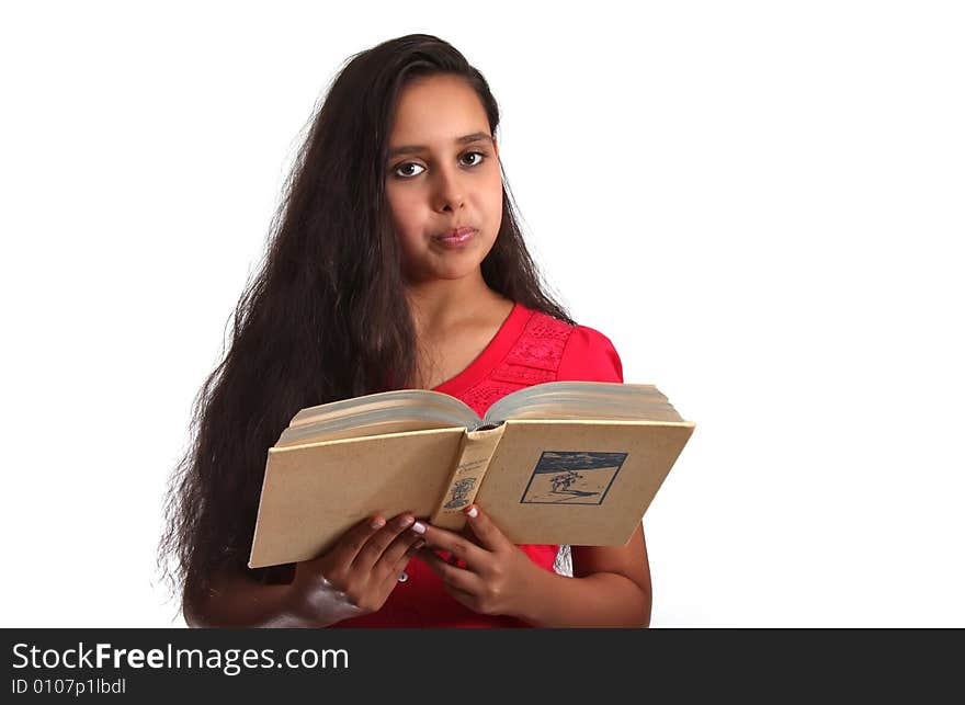 11 year old girl, holding a book close to herself. 11 year old girl, holding a book close to herself