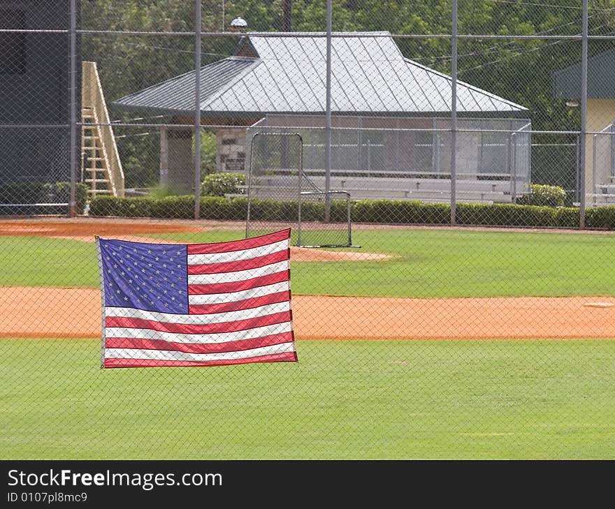 A baseball outfield with american flag in foreground. A baseball outfield with american flag in foreground