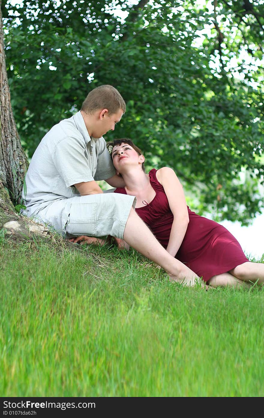 Happy young couple relaxing near the river