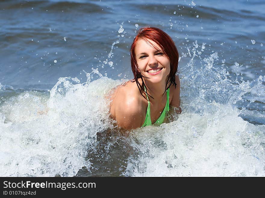 Happy young girl having fun on the sea