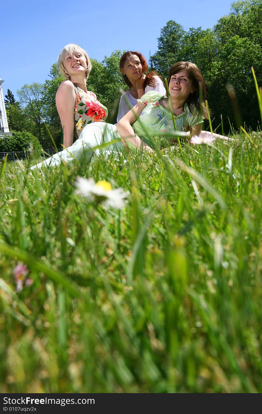 Three happy girls relaxing outdoors. Three happy girls relaxing outdoors