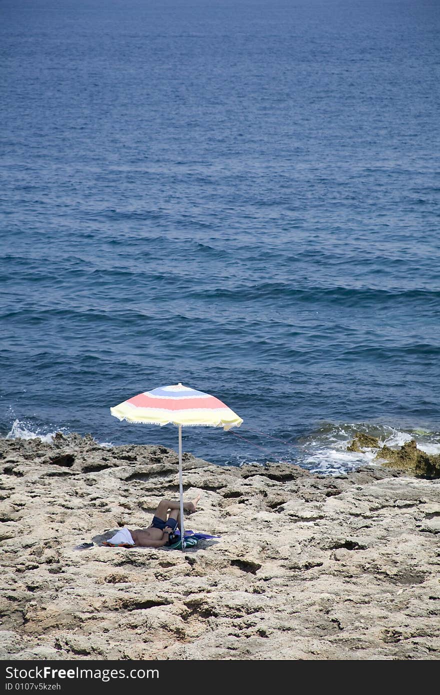 Alone on the beach with sun umbrella