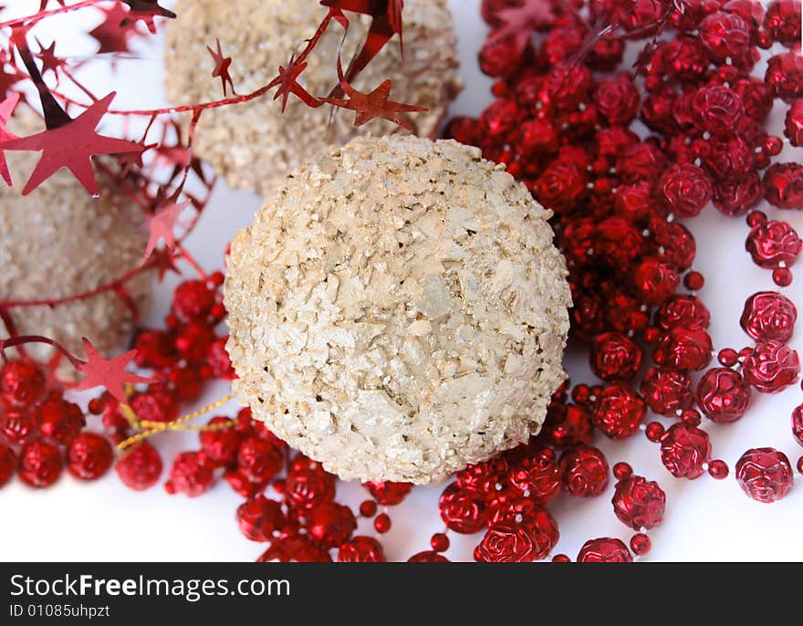 Christmas decorations, shiny gold sphere and red garland