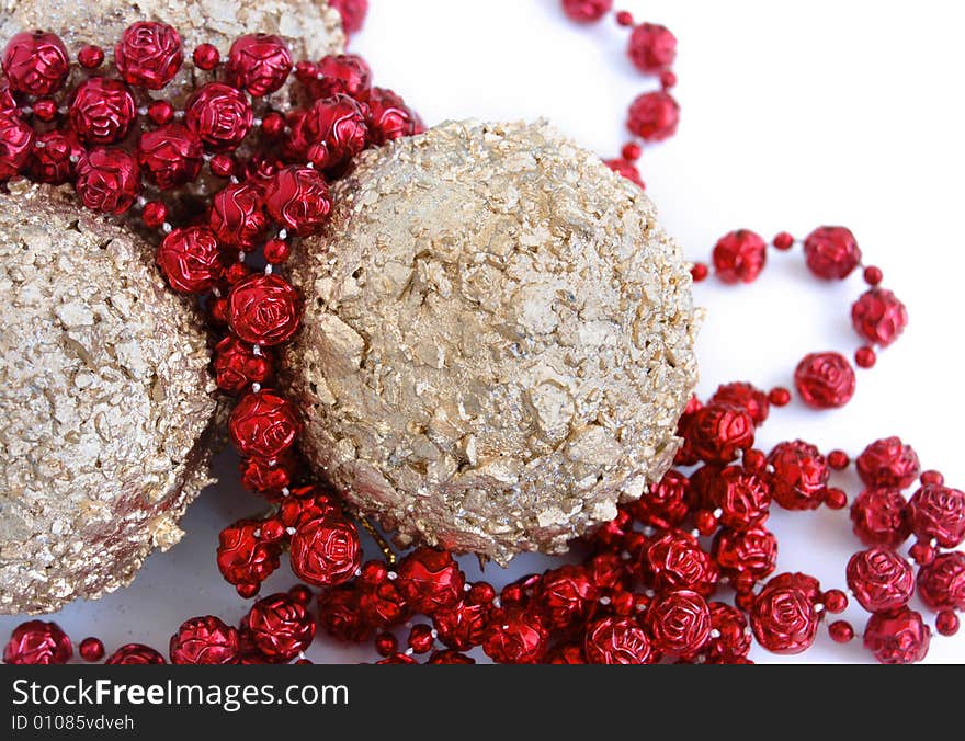 Christmas decorations, shiny gold sphere and red garland