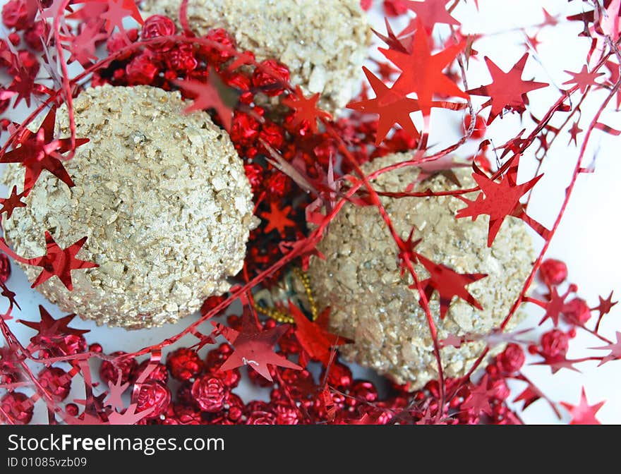 Christmas decorations, shiny gold sphere and red garland