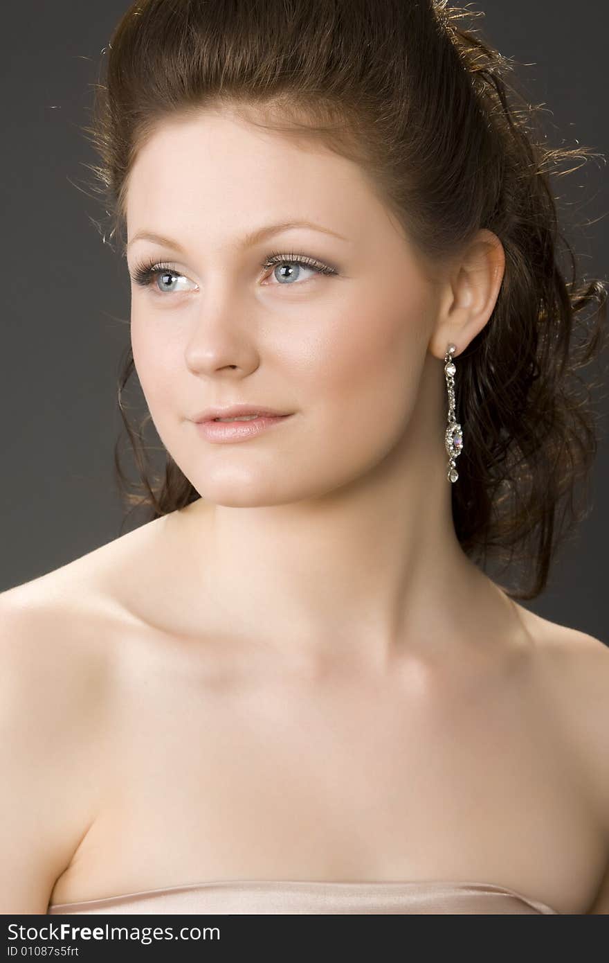 Portrait of young beautiful woman on gray background