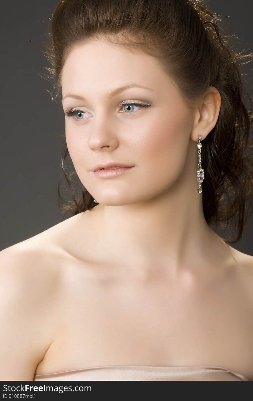 Portrait of young beautiful woman on gray background