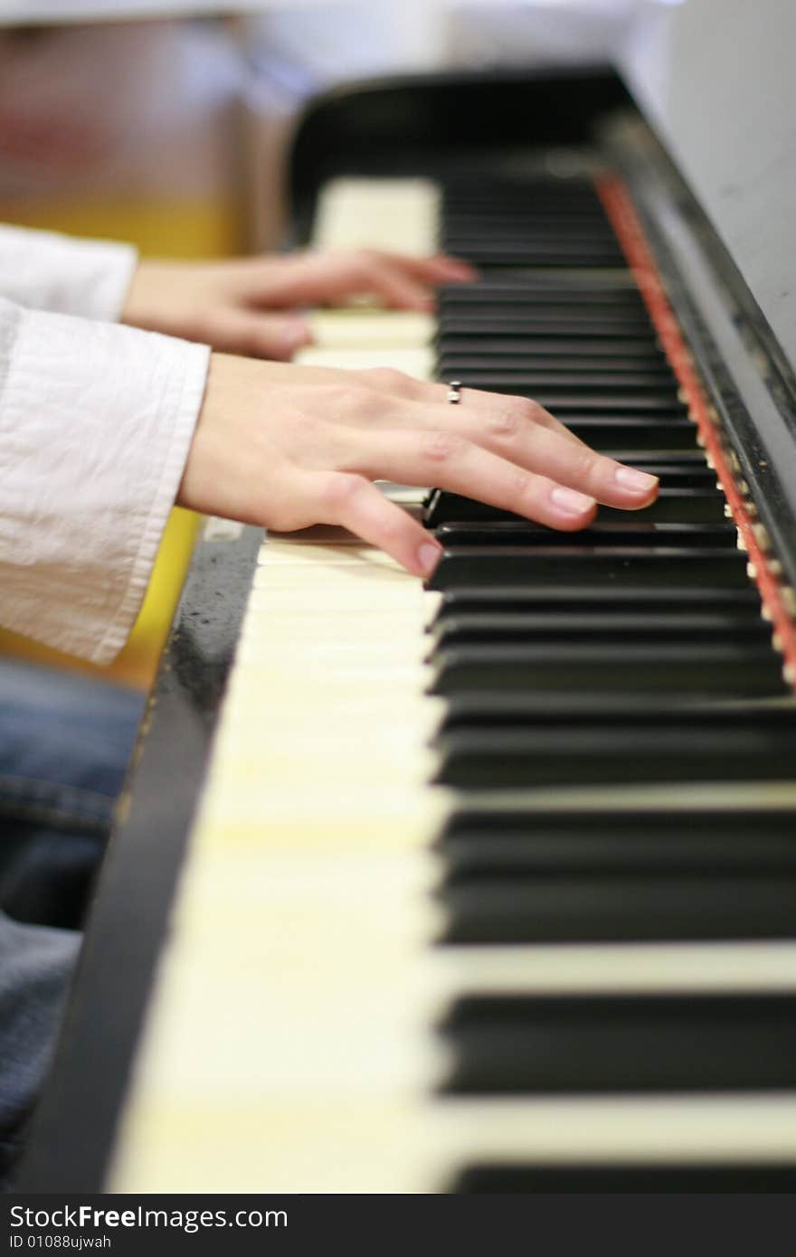 Playing the piano - young woman