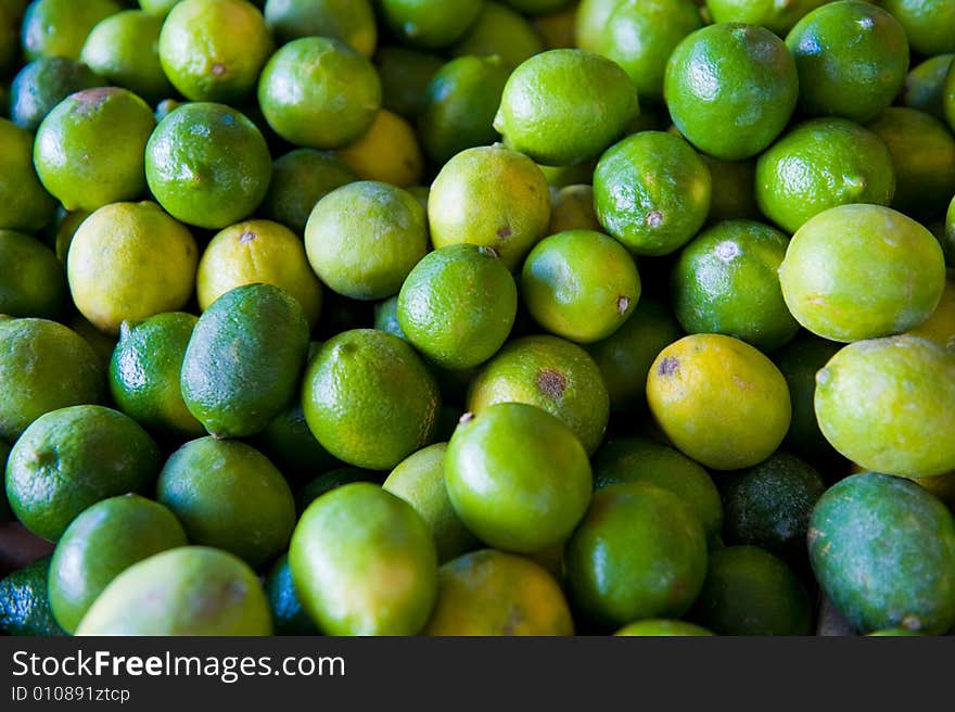 An image of fresh vibrant limes at an outdoor market