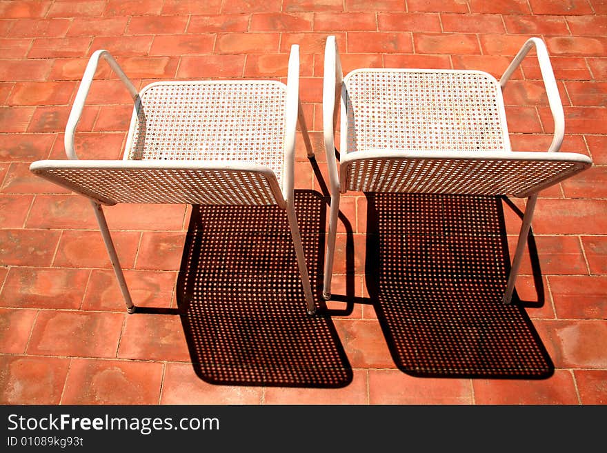 Two chairs for a sunbath on the terrace, nice shadows. Two chairs for a sunbath on the terrace, nice shadows