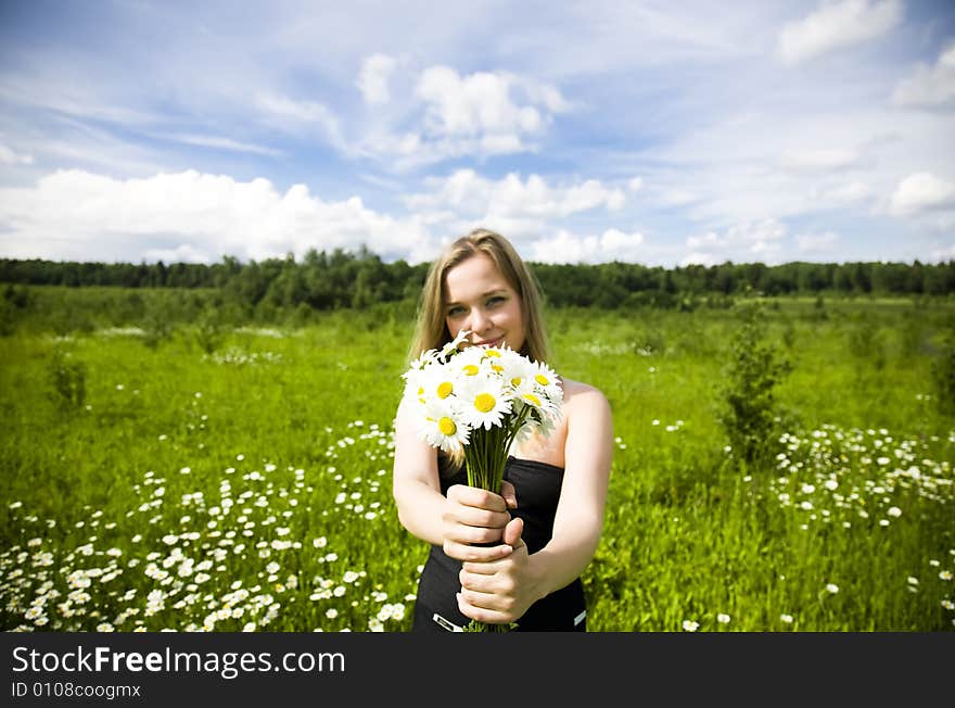 Woman With Flowers On The Meadow