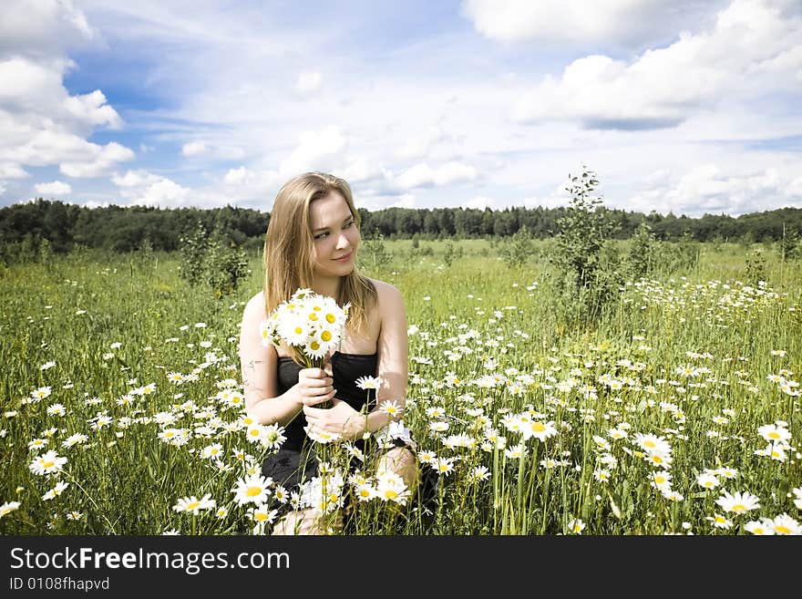 Young Woman With Flowers Relaxing Outdoors. Young Woman With Flowers Relaxing Outdoors