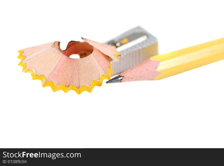 Pencil and a metal sharpener isolated on white. Pencil and a metal sharpener isolated on white