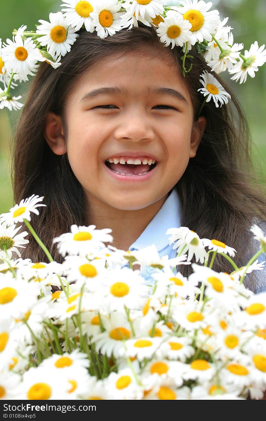 Beautiful little girl with crown of daisies