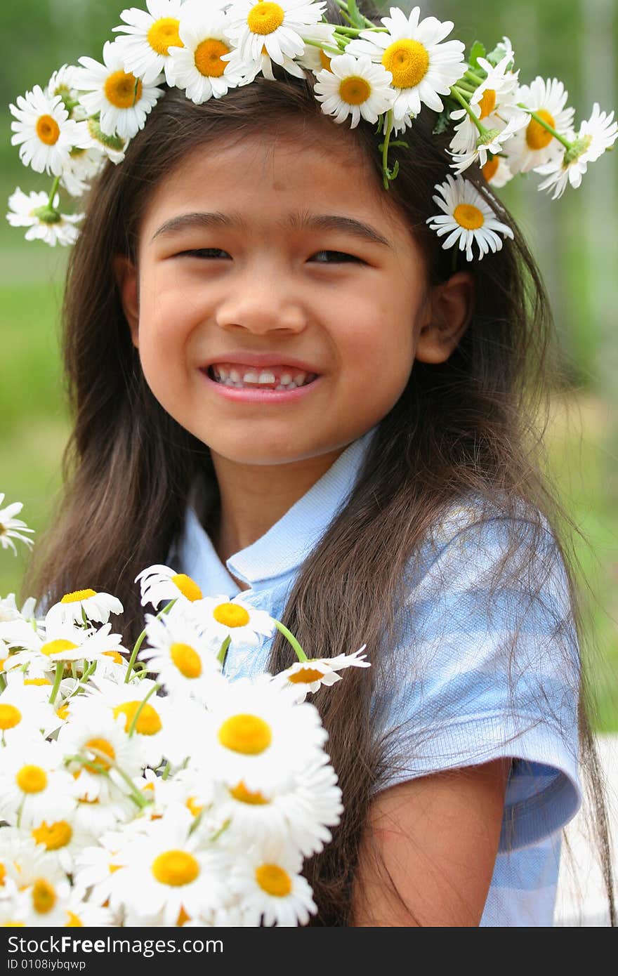 Beautiful little girl with crown of daisies