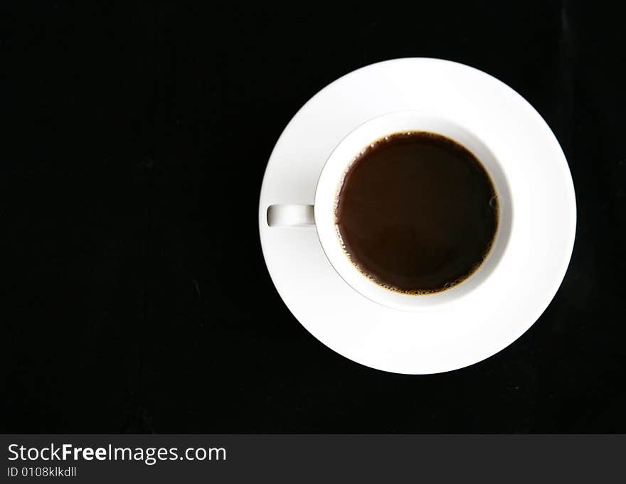 Top view of a cup of coffee on a saucer.