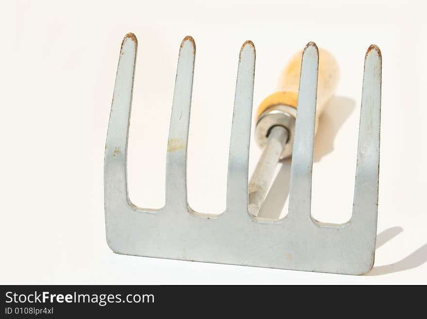 Hand rake against white background