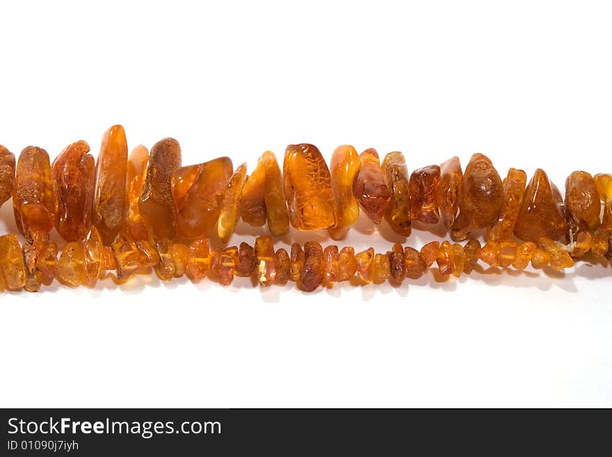 Thread of amber bead on white background. close-up. Thread of amber bead on white background. close-up.