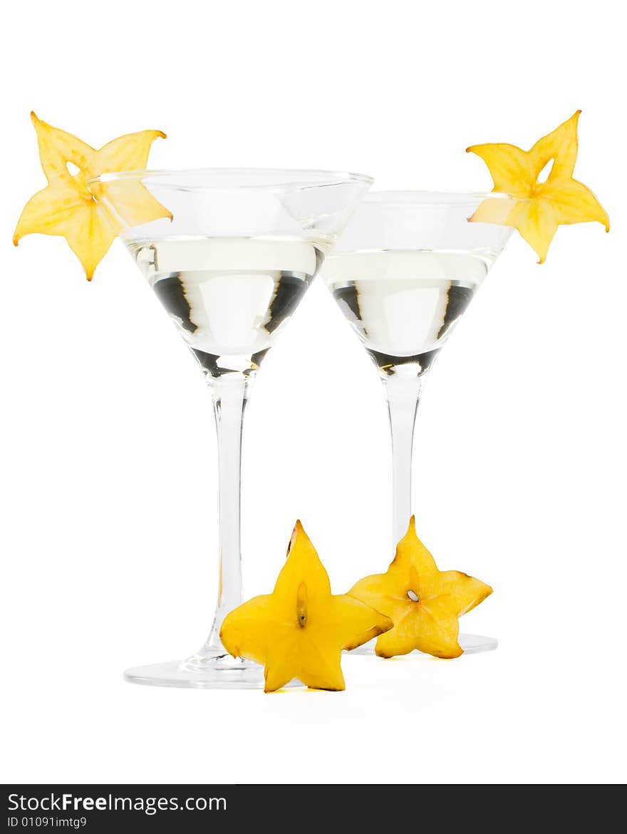 Glass of martini and slice of carambola on a white background. Glass of martini and slice of carambola on a white background