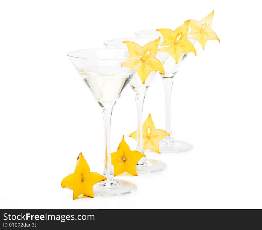 Glass of martini and slice of carambola on a white background. Glass of martini and slice of carambola on a white background