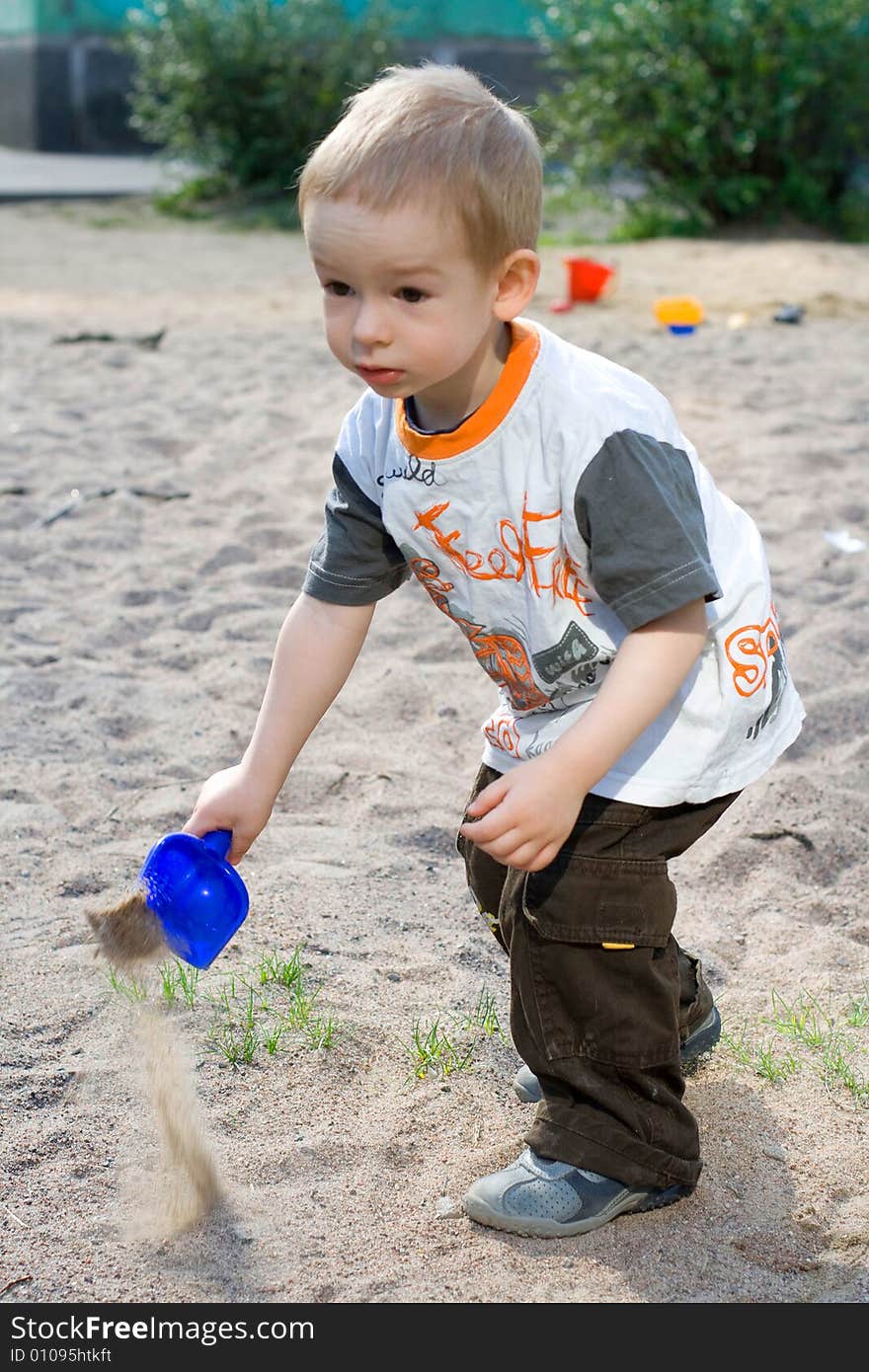 Boy playing in sand-box