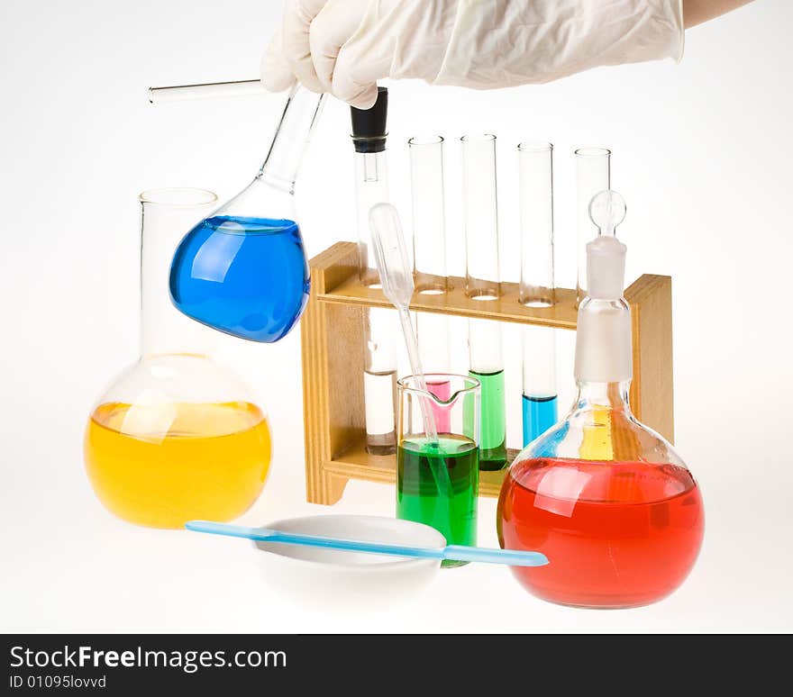 Various colorful glass laboratory ware on a white background. Various colorful glass laboratory ware on a white background