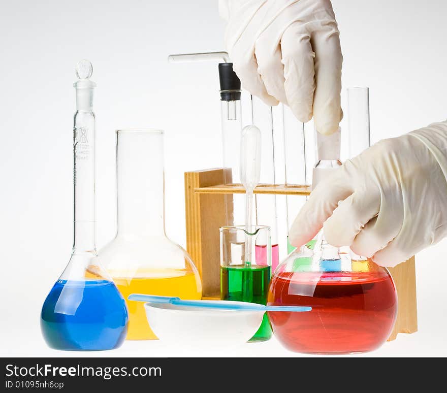 Various colorful glass laboratory ware on a white background. Various colorful glass laboratory ware on a white background