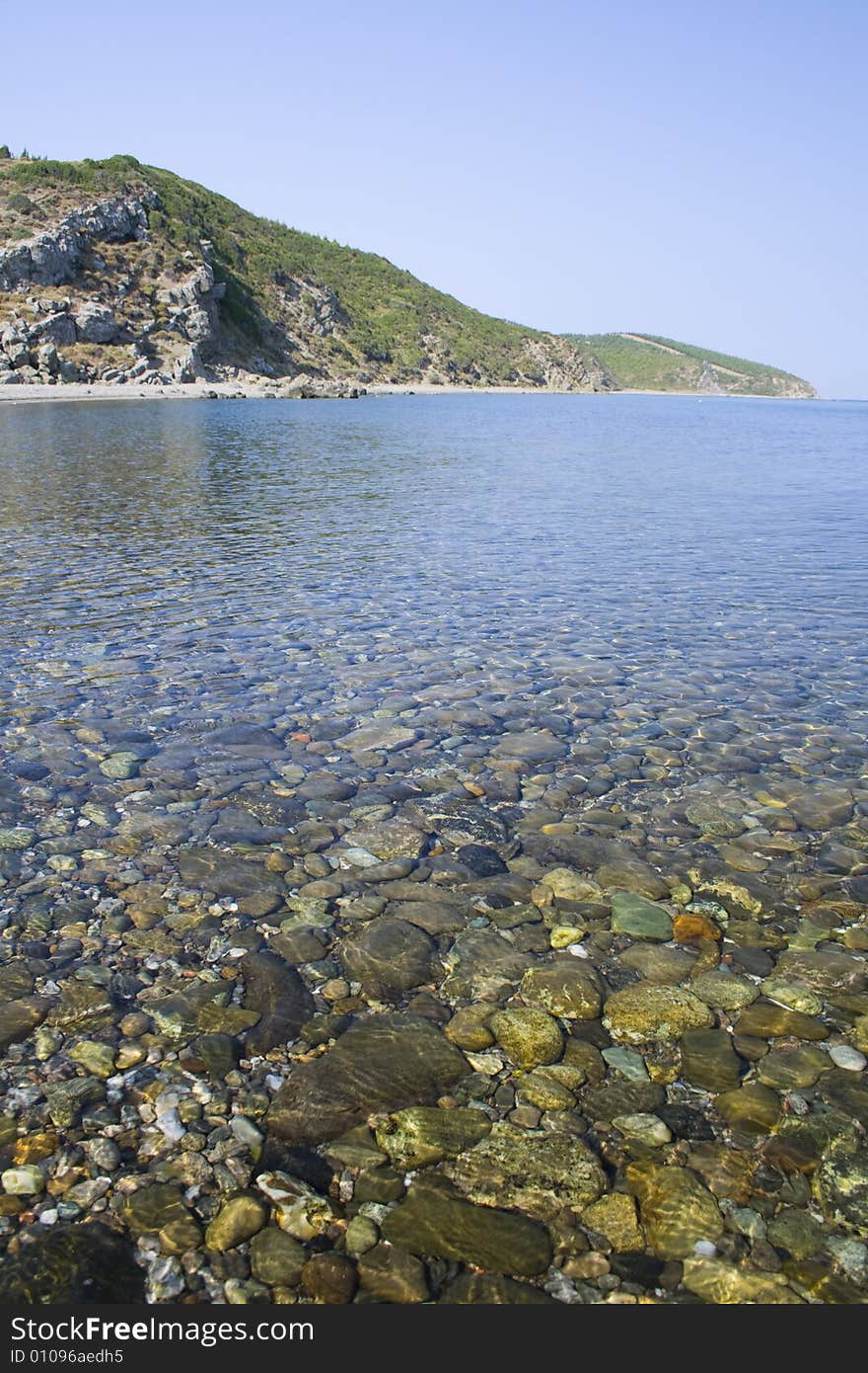 Mountains in the sky and pebbles underwater. Mountains in the sky and pebbles underwater