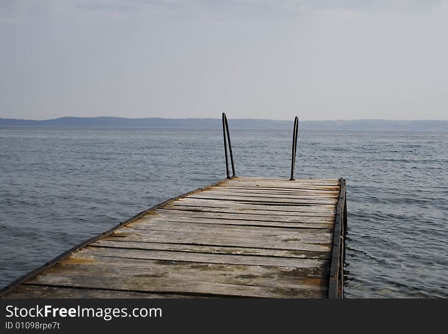 View from old rusty wharf in the calm sea. View from old rusty wharf in the calm sea