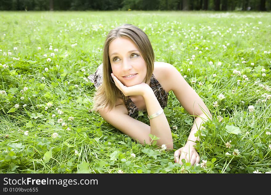 The Woman Laying On A Meadow