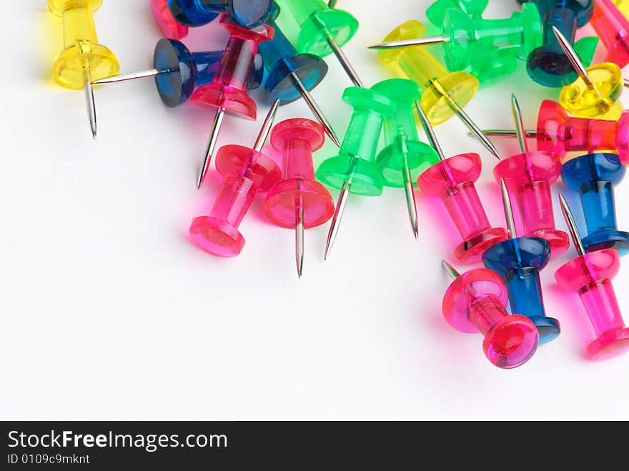 Multicoloured push-pins on white background. Multicoloured push-pins on white background