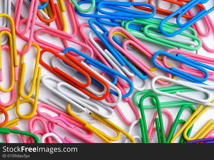 Multicoloured paperclips on white backgraund