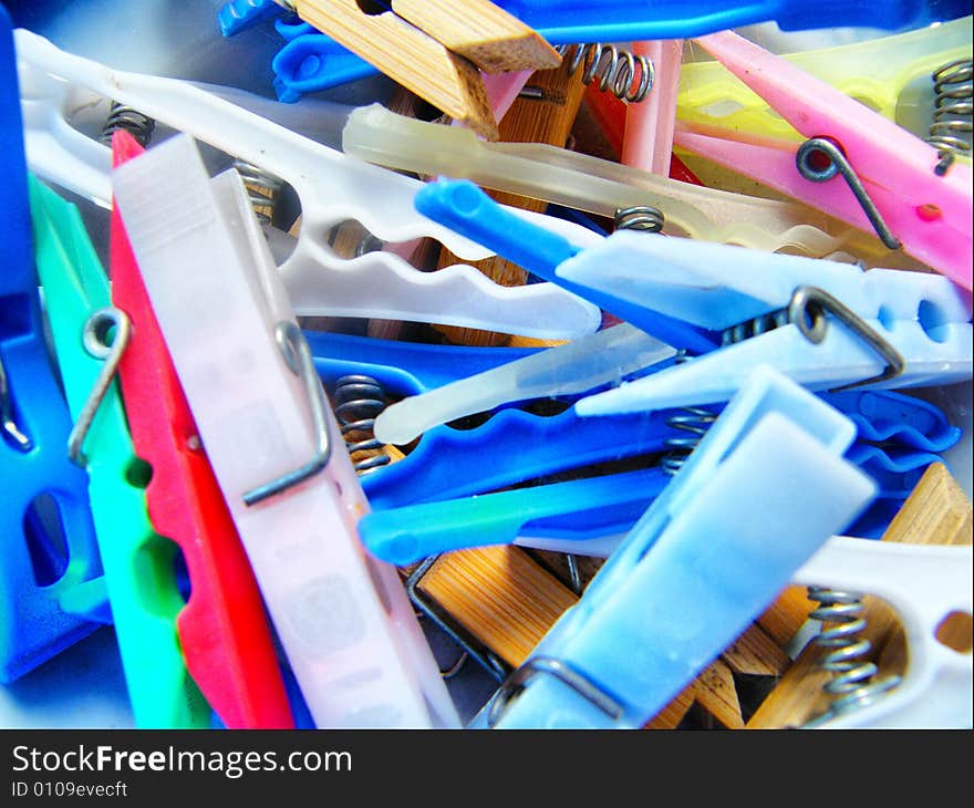 Many different multi-coloured clothespins