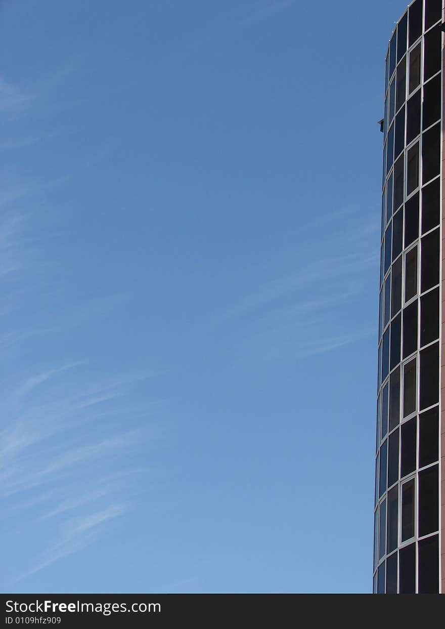 Skyscraper and blue sky with clouds