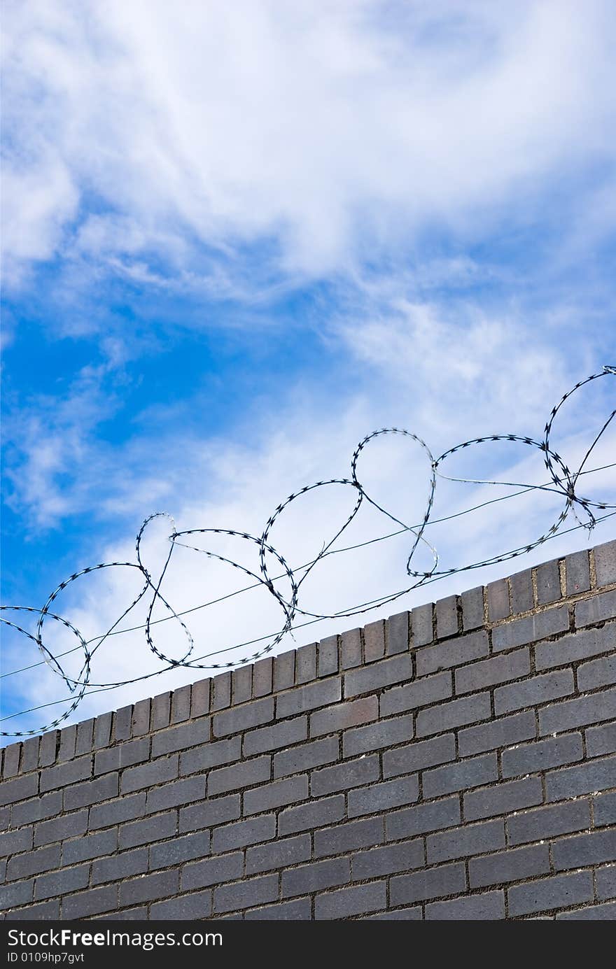 Barbed wire on a brik wall