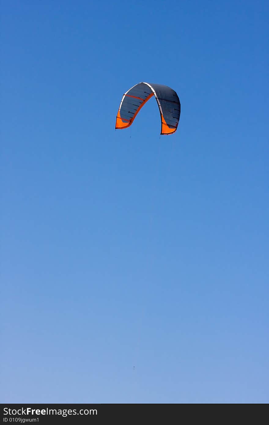 A surf kite against a blue sky. A surf kite against a blue sky