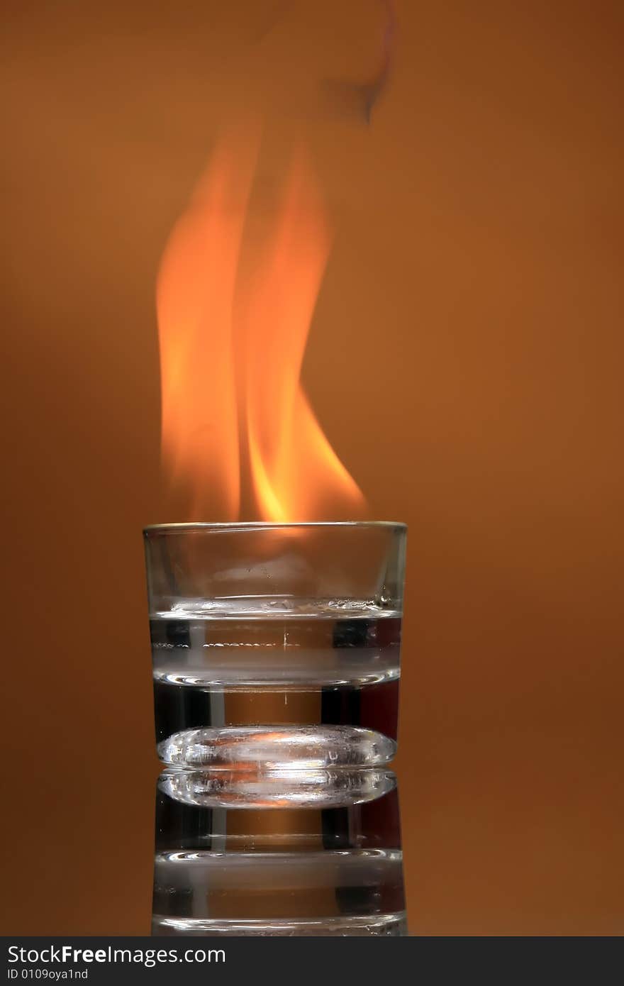 Photo of a burning glass on orange. Photo of a burning glass on orange