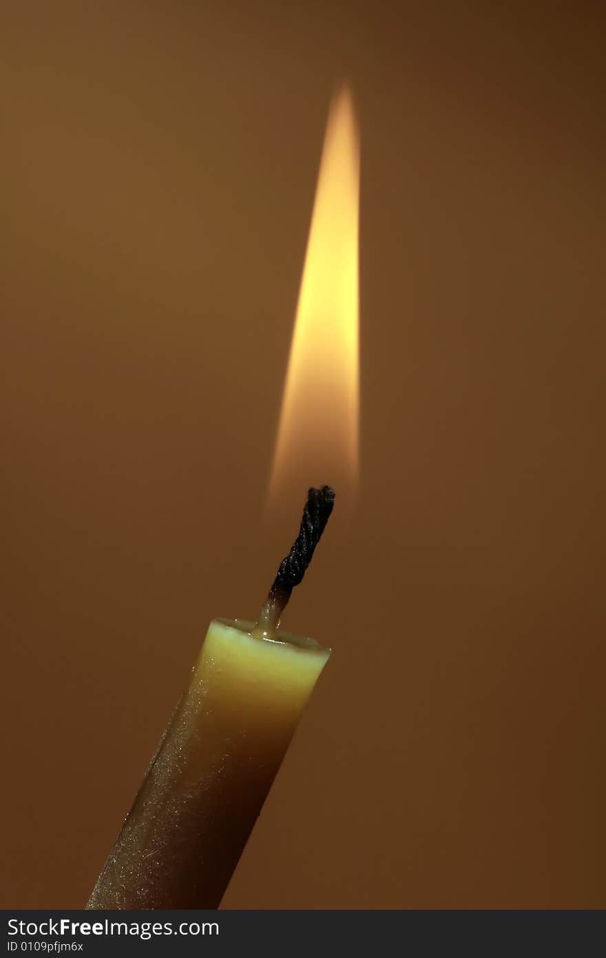 Photo of a burning candle on background. Photo of a burning candle on background