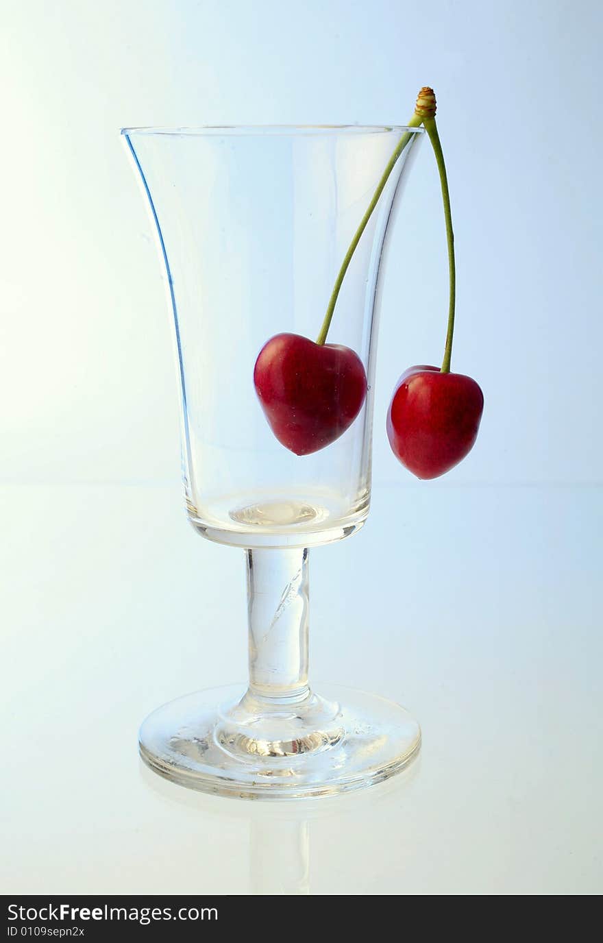 Ripe cherries in a glass on white background. Ripe cherries in a glass on white background