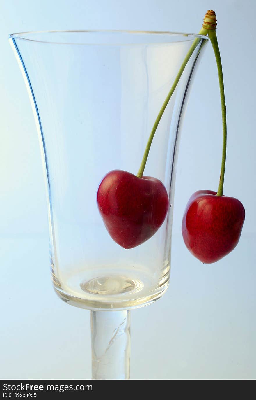 Ripe cherries in a glass on white background. Ripe cherries in a glass on white background