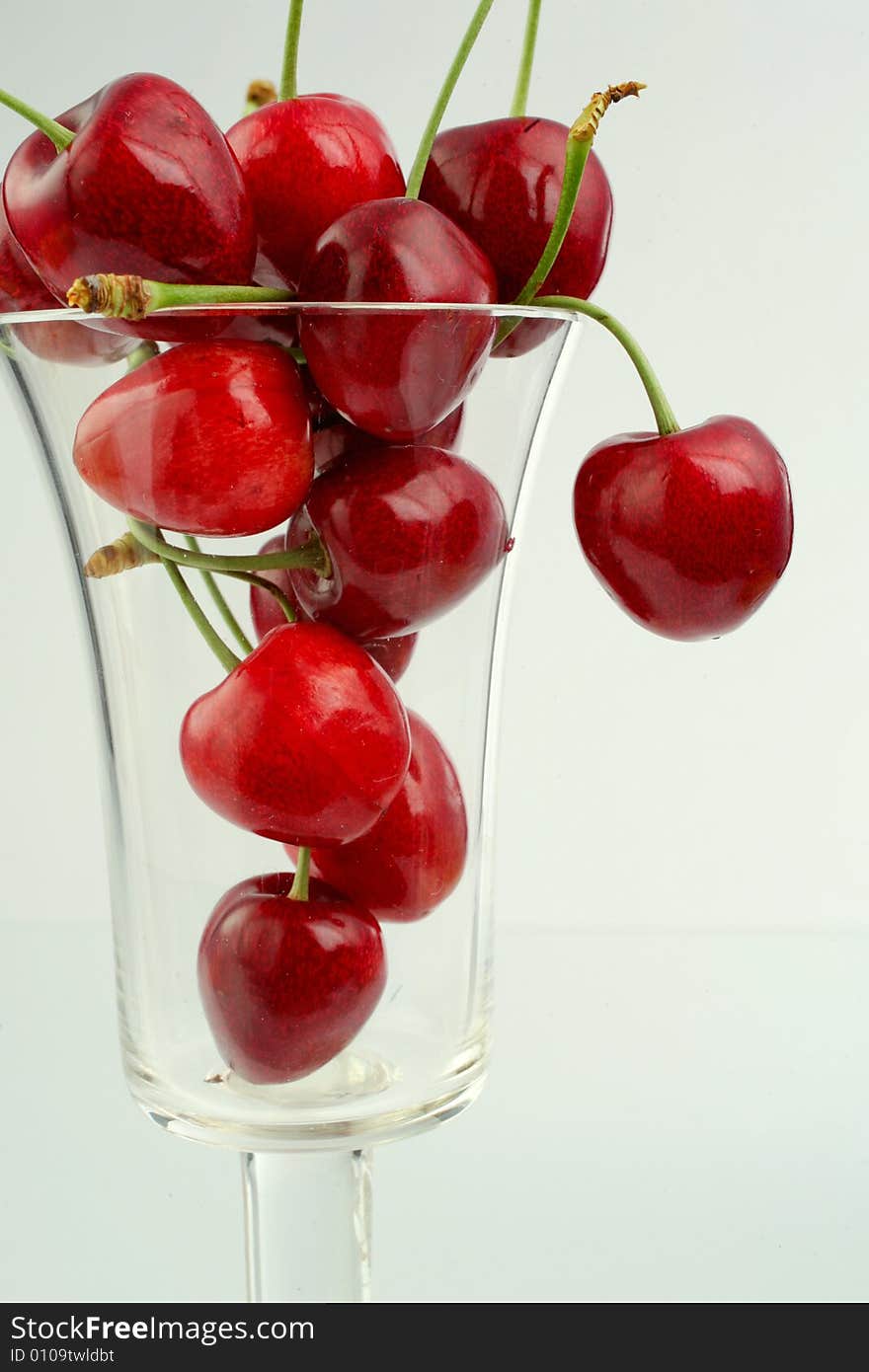 Ripe cherries in a glass on white background. Ripe cherries in a glass on white background